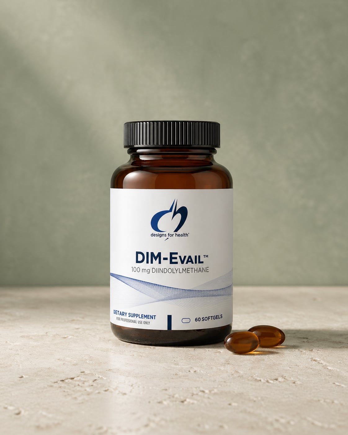 Designs for Health DIM-Evail amber bottle on a warm stone surface against a soft sage-green wall, with two amber softgels resting beside it