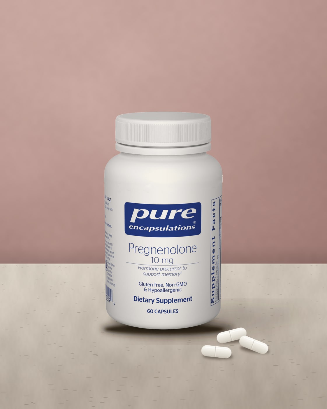 Pure Encapsulations Pregnenolone 10 mg bottle on a pale stone ledge against a dusty rose wall with white capsules beside it