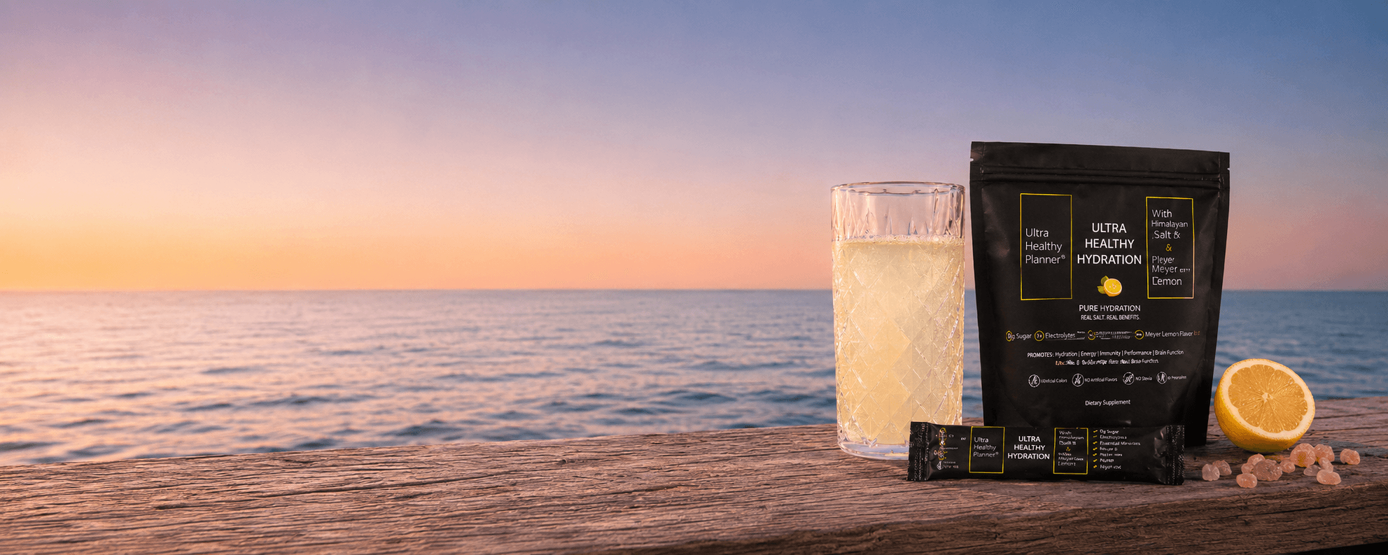 Ultra Healthy Hydration packet and a glass of mineralized water at dawn on a coastal balcony, ocean horizon in the distance