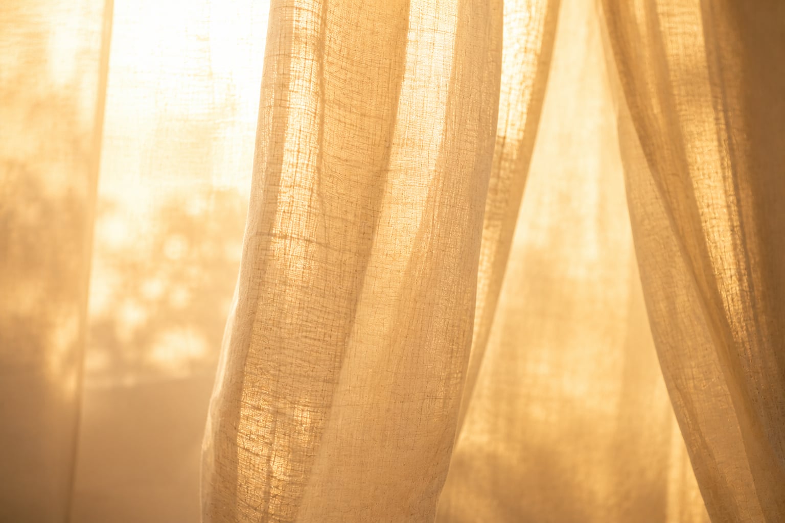 Warm morning light glowing softly through sheer linen