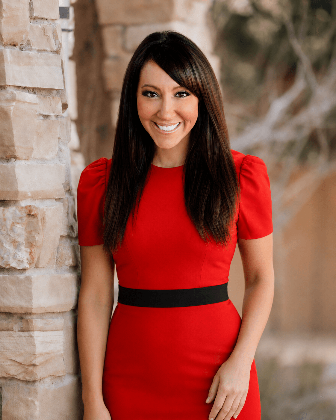 Dr. Nicole Srednicki at her desk, writing in a leather-bound journal in her Scottsdale practice